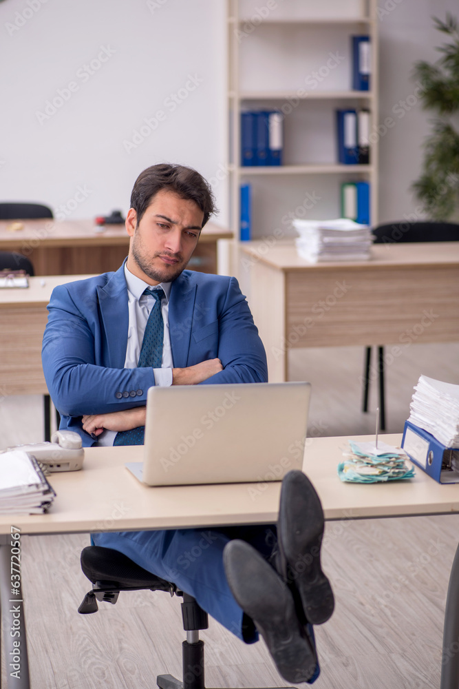 Young male employee working in the office