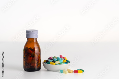1 bottle of medicine without labels  and medicine cup on a white background