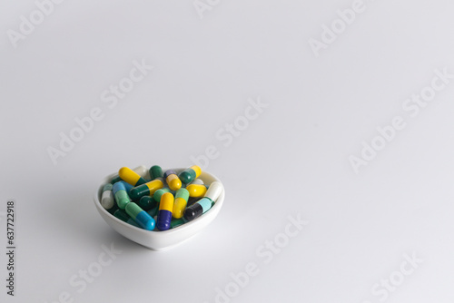 one cup of medicine capsule on white background