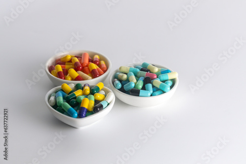 three cup of medicine capsule on white background