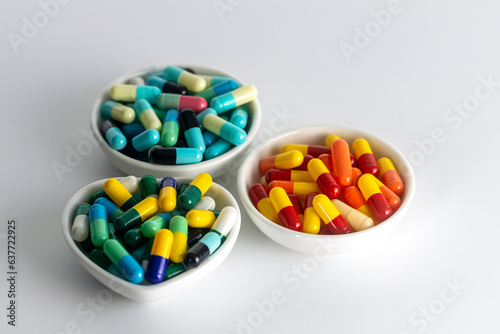 three cup of medicine capsule on white background