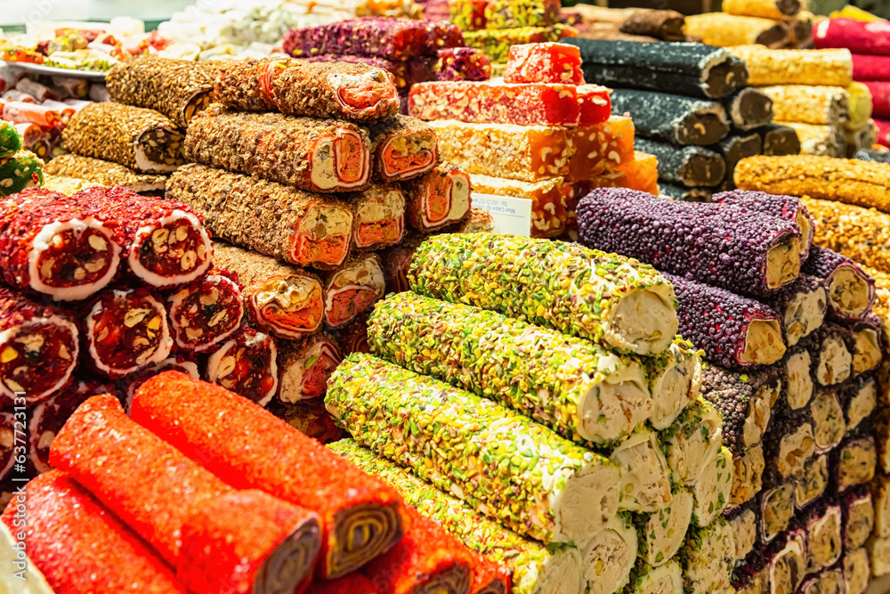Fototapeta premium Set of multicolored turkish locum with nougat, nuts and fruits. Sweets and traditional oriental delights concept. Street market, Istanbul, Turkey