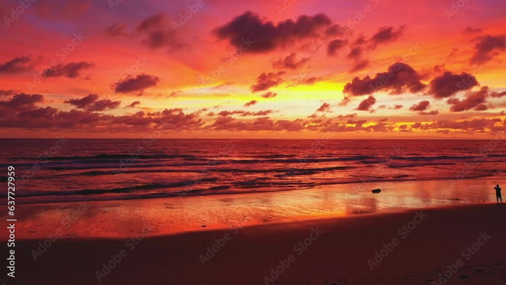 Frying drone on the beach in colorful reflection of stunning sunset..beautiful scene with the sun painting the sky above waves .breaking gently on a sandy.Gradient color. abstract nature background. Frying drone on the beach in colorful reflection of stunning sunset..beautiful scene with the sun painting the sky above waves .breaking gently on a sandy.Gradient color. abstract nature background.