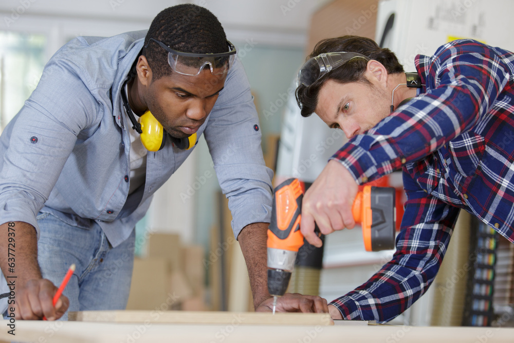 young apprentice and wood professional drilling wood young apprentice and wood professional drilling wood