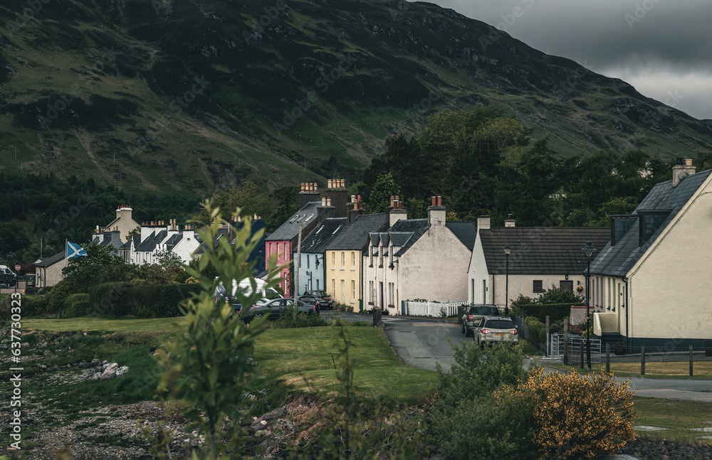 The view of the colorful townhouses in Dornie Town in Scottish Highlands in overcast weather