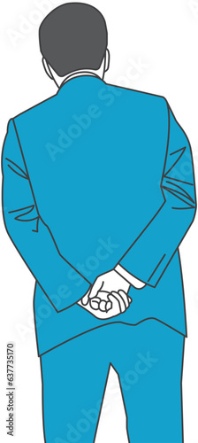 A man in a suit with his hands folded behind his back