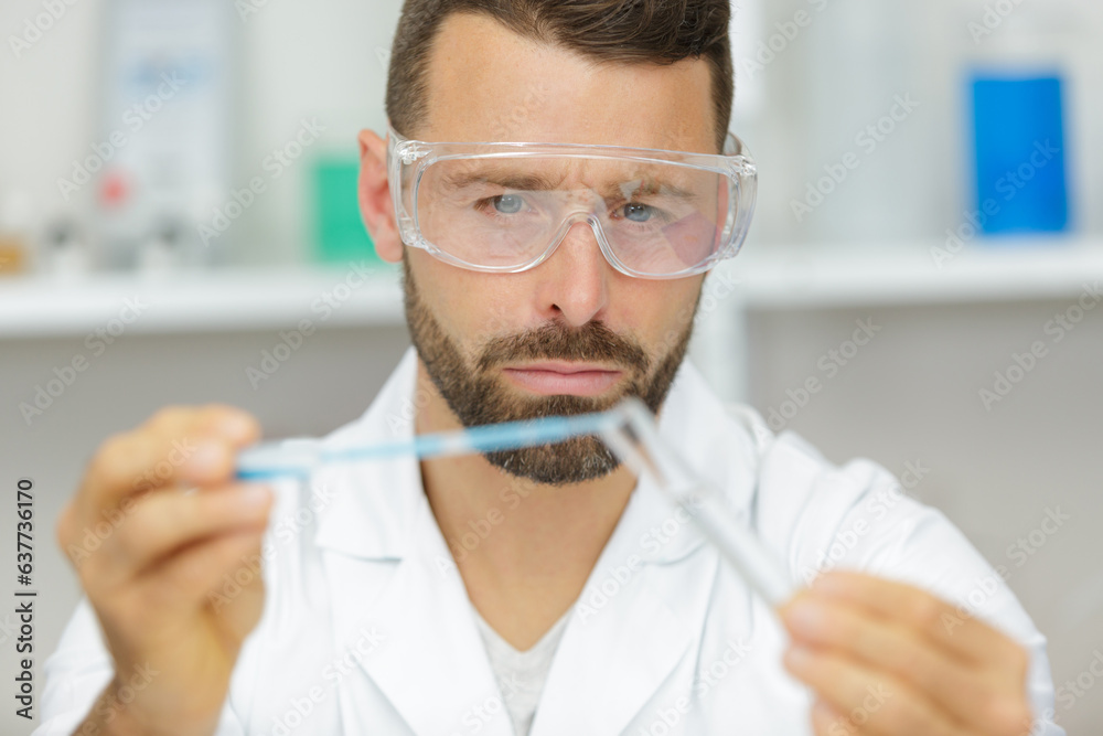 handsome student of chemistry working with chemicals handsome student of chemistry working with chemicals