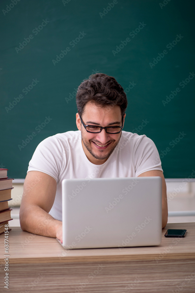 Young male student sitting in the classroom Young male student sitting in the classroom