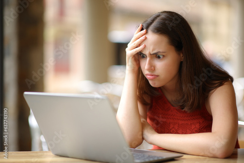 Fototapeta Frustrated woman cheking laptop after mistake