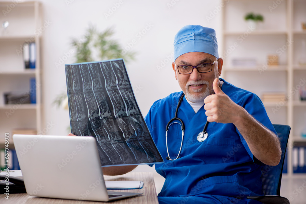 Old male doctor radiologist working in the clinic Old male doctor radiologist working in the clinic