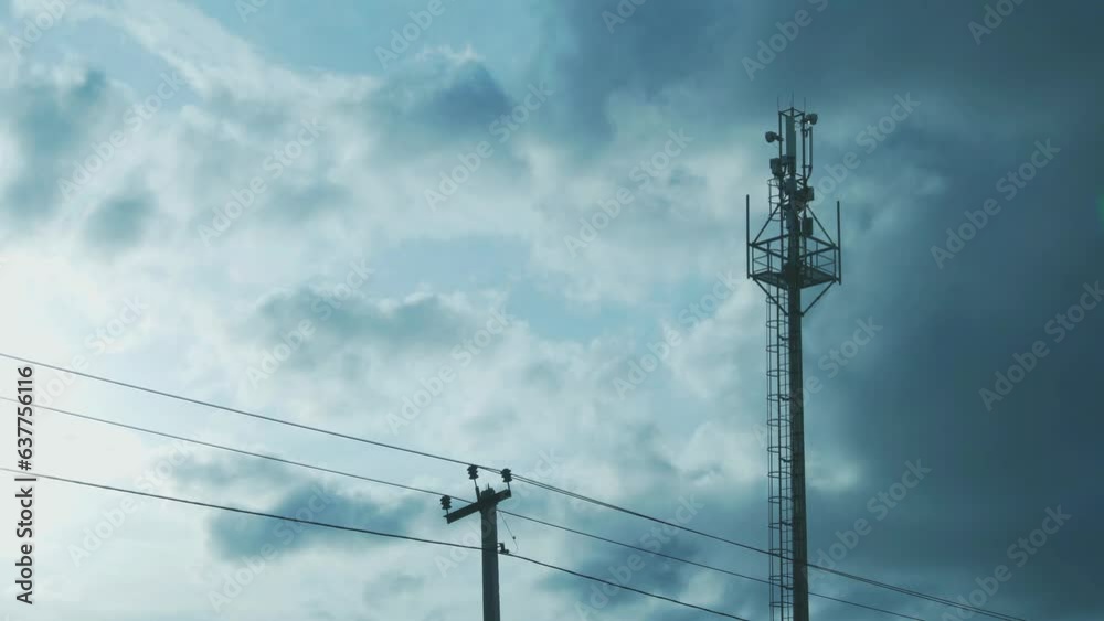 Cell Tower of Mobile Operators and Time Lapse of White Gray Clouds in the Blue Sunny Sky. Cellular Communications. Cell Tower of Mobile Operators and Time Lapse of White Gray Clouds in the Blue Sunny Sky. Cellular Communications.