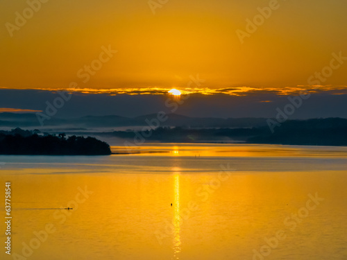 Winter golden hour sunrise over the bay and mountains with fog