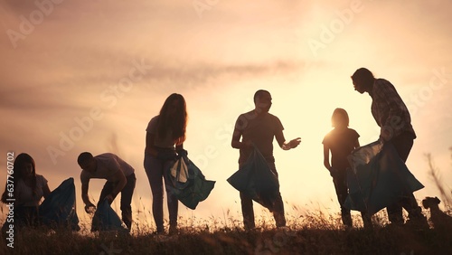 silhouette volunteers collect plastic. group team people collect plastic bottles sunset together. environmental protection business concept. volunteers family lifestyle collect plastic clean nature