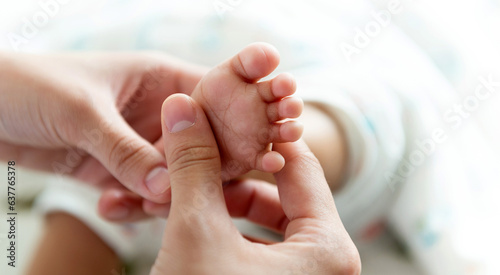 Close up of doctor hands massaging baby foot