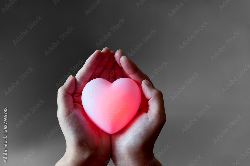 Human hand holding a red heart