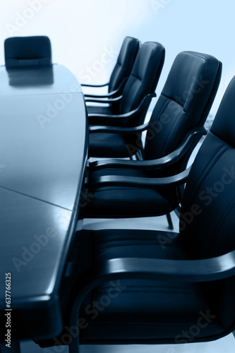 Empty meeting room with table and row of chairs photo