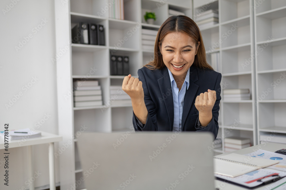 Asian woman looking at the company's profitable sales and earnings summary and showing a happy expression, she is happy that the company has met its target and has more growth. Asian woman looking at the company's profitable sales and earnings summary and showing a happy expression, she is happy that the company has met its target and has more growth.