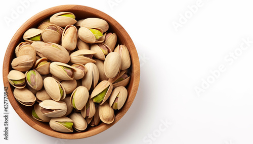 Pistachio nuts in wooden bowl isolated on white background.
