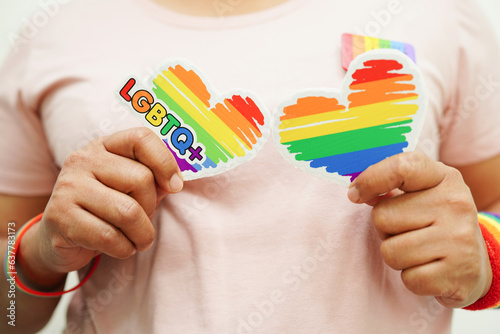 Asian woman with rainbow flag, LGBT symbol rights and gender equality, LGBT Pride Month in June.