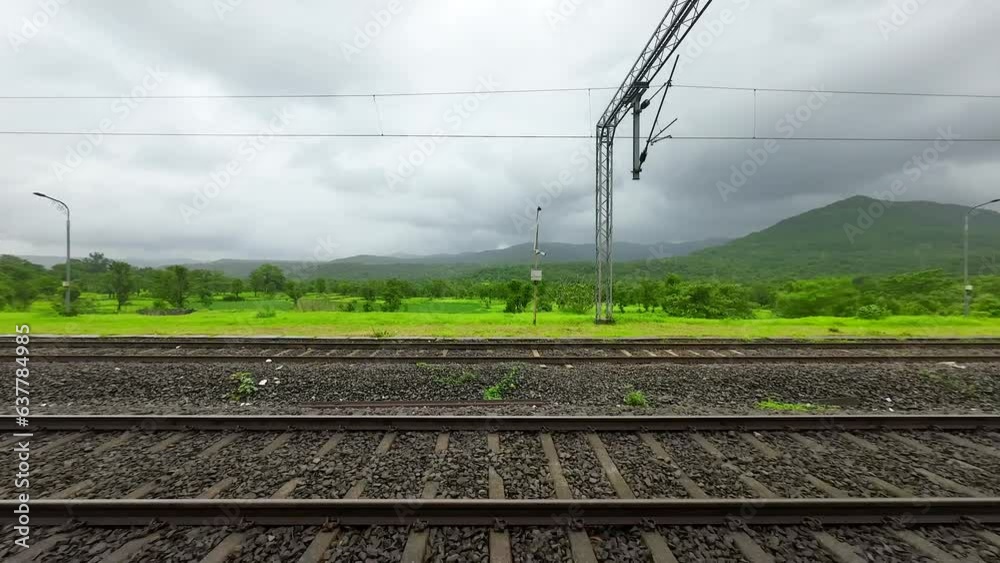 greenery forest hyper laps in rain view from train window in Konkan railway