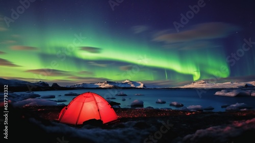 Red tent located on shore of glacial Jokulsarlon Lake under the northern sky