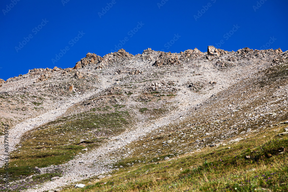 The ridge of the mountain against the background of an amazing blue sky