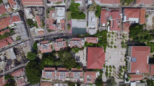 The small apartment complexes of the Neve Tzedek neighborhood in Tel Aviv from a high altitude by drone - top down shot photo
