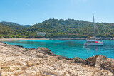 Turquoise water bay of Adriatic sea on Hvar island with yacht in Dalmatia region, Croatia in sunny day