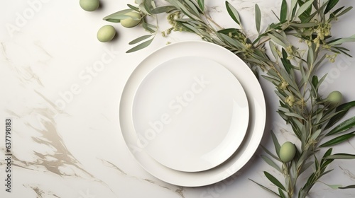 Top view of an elegant wedding table with invitation card and porcelain plates adorned with olive branches A modern template with a blank vertical paper card lai. Mockup image