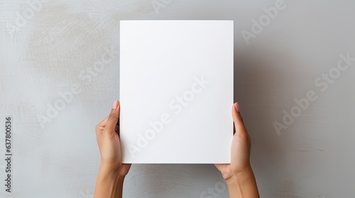 Female hands holding blank magazine gray background design template. Mockup image photo