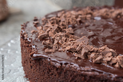 Close up of a delicious looking dark chocolate cake with icing