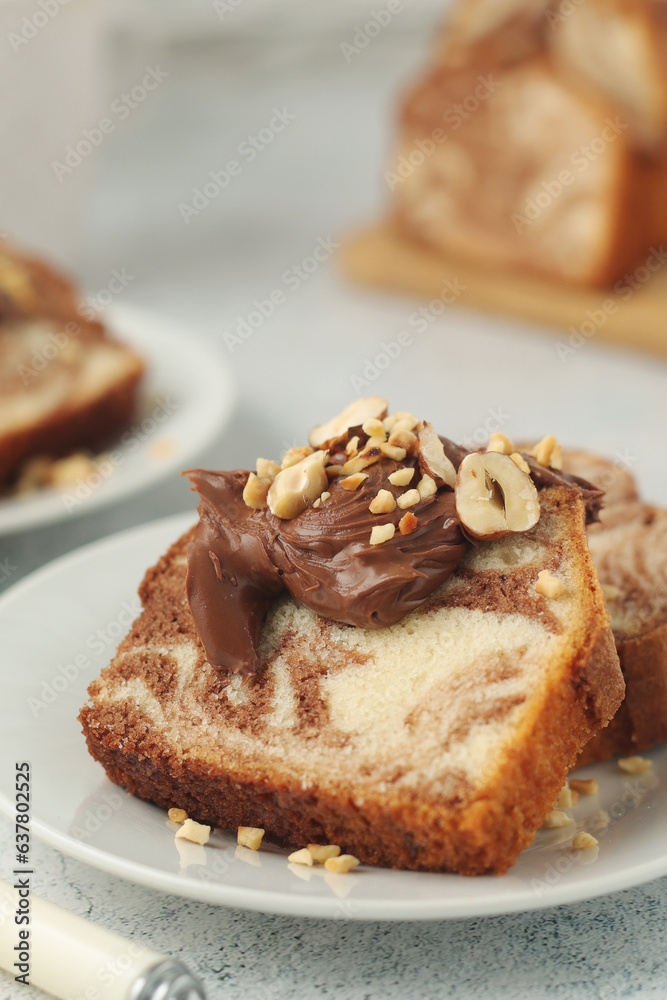 A piece of marble biscuit with chocolate cream and nuts A piece of marble biscuit with chocolate cream and nuts