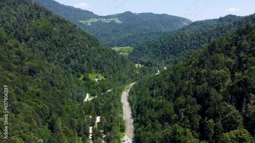 Idrijica River in valley, beautiful forested mountain surroundings, Slovenia natural landscape. Drone photo