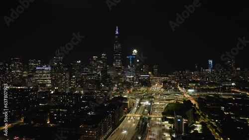 Aerial tracking shot over the West loop and the illuminated Chicago skyline, in Il, USA photo