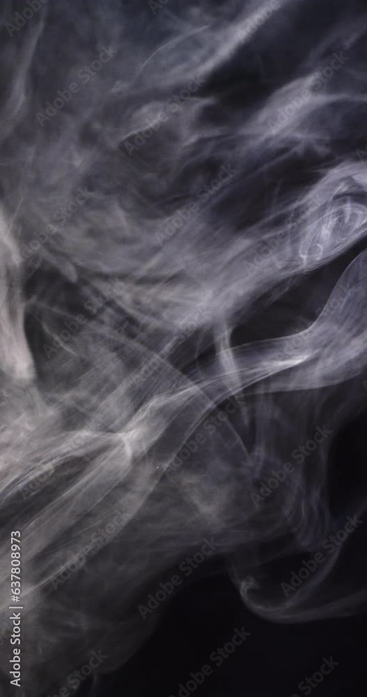 Vertical video of white clouds of smoke moving with copy space on black background Vertical video of white clouds of smoke moving with copy space on black background