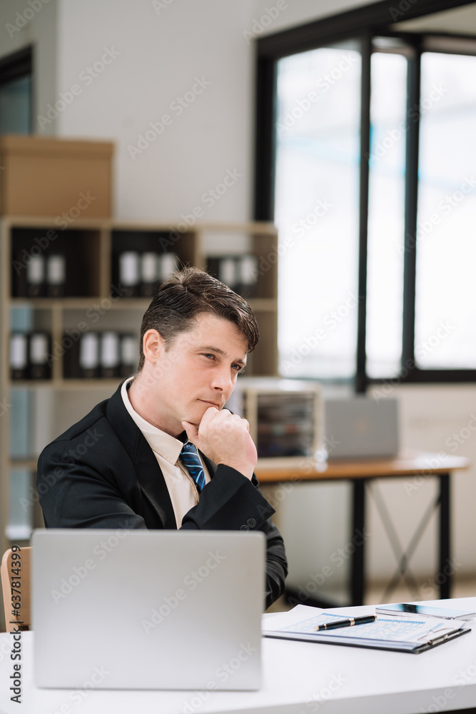 Business man sitting at his desk in the office.