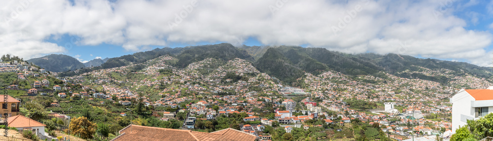 Full panoramic view of the high lands on city of Funchal and Camara de Lobos, mountains as background, on the island of Madeira, in Portugal