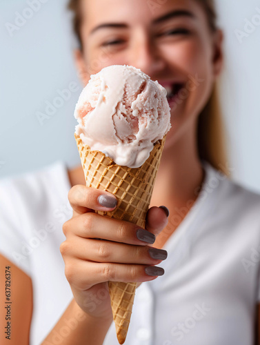 Woman holds ice cream cone in front of her and is in a good mood