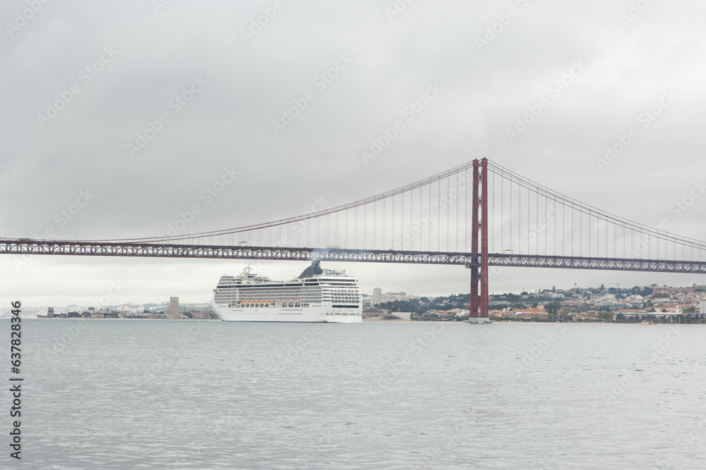 Huge cruise ship passes along the river under the bridge in cloudy weather Huge cruise ship passes along the river under the bridge in cloudy weather