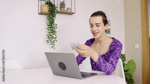 Young gay man makes online purchases with credit card