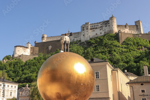 Salzburg; Blickfang auf dem Kapitelplatz, Skulptur Sphaera vor der Festung Hohensalzburg photo