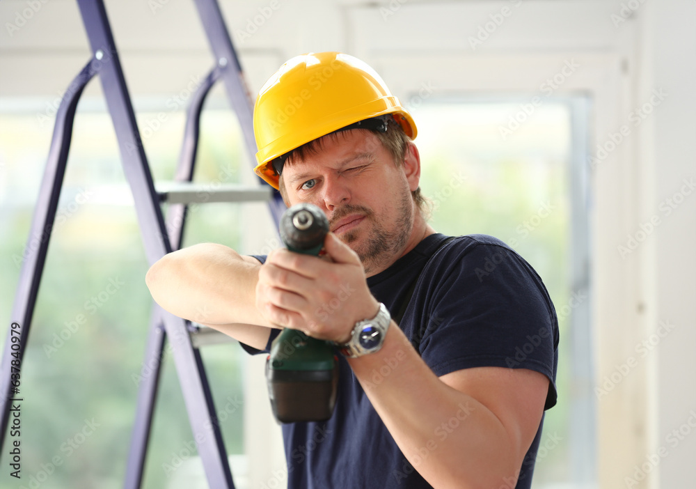 Arms of worker using electric drill closeup. Manual job DIY inspiration improvement fix shop yellow helmet joinery startup idea industrial education profession career concept Arms of worker using electric drill closeup. Manual job DIY inspiration improvement fix shop yellow helmet joinery startup idea industrial education profession career concept