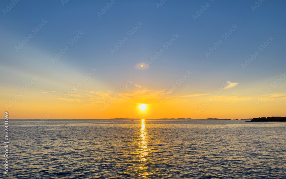 Sunset of the bright sun on the sea. You can see beautiful rays.