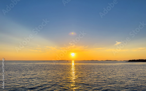 Sunset of the bright sun on the sea. You can see beautiful rays.