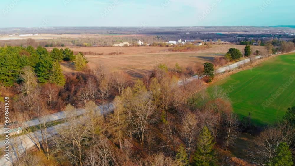 Aerial view along road between the fields and golden fall forest of north america. Farming, fields with harvest, north american golden fall forest is best tourist place in fall to camping and photo. Aerial view along road between the fields and golden fall forest of north america. Farming, fields with harvest, north american golden fall forest is best tourist place in fall to camping and photo.