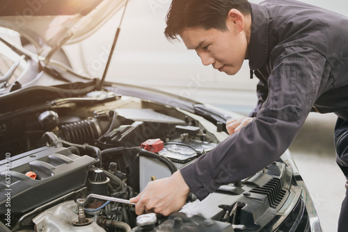 professional mechanic male check fix service car engine in garage auto workshop