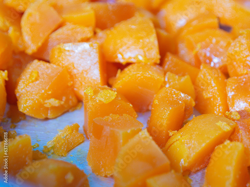 Egg yolks are cut into many pieces, bright orange, taken from the front.