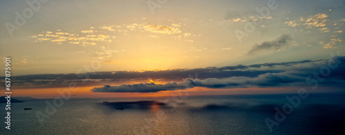 A panoramic  view of  sunset above the mediterranean sea during the golden hour with sun hidden by clouds.Overlooking view of the the mediterranean sea during sunset in Canastel forest Oran Algeria © Iceman_31