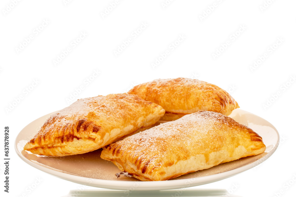 Three fragrant puff pastry buns with apples on a white ceramic plate, close-up, isolated on a white background.