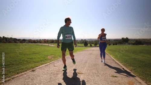 high level runners in a marathon - people who compete in fitness and healthy active lifestyle on the road. mature couple running a race photo